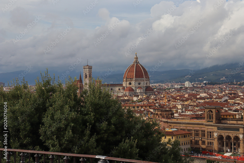 Obraz premium Florence cityscape with Duomo and Bargello tower, Arno river reflecting warm sunset light