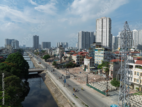 Obraz na płótnie Wide urban landscape of demolished properties and expanding roadway near dense residential districts along Tam Trinh corridor in Hanoi