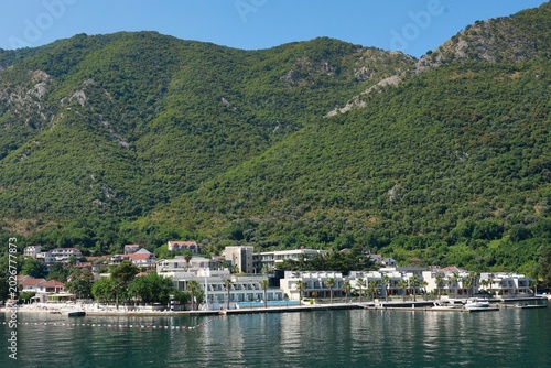 Coastal resort town nestled against lush green mountains by the sea