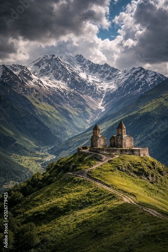 Ancient mountain monastery overlooks lush valleys and snowy peaks, capturing timeless spirituality, breathtaking landscapes and the beauty of remote nature.