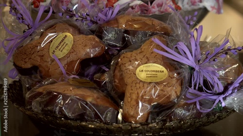 Italy, Volpiano, 03-20-2026. Artisanal wrapped Easter doves. Easter time. Panning 4K