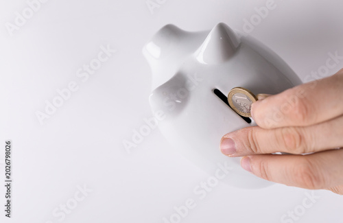 Hand inserting a euro coin ...