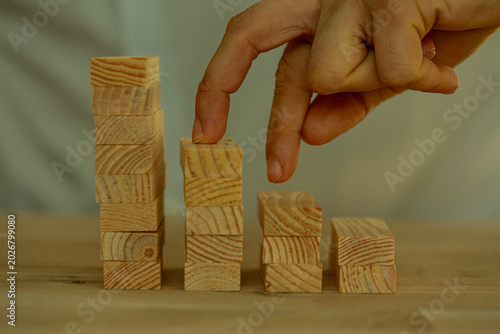 Quadro em tela Fingers mimic walking down wooden blocks arranged in a declining bar chart