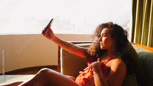 Tableau sur toile Young woman creating content and sharing a moment of leisure with her phone