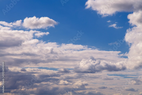 Blue sky with white cumulus clouds on sunny day panorama.