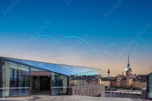 Digital blue arcs seen in clear sky representing network with famous church