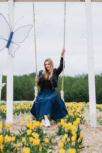 A young woman in a field of tulips. 