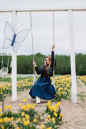 A young woman in a field of tulips. 