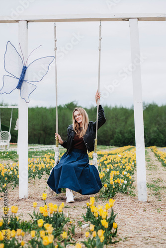 A young woman in a field of tulips. 