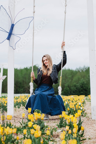 A young woman in a field of tulips. 