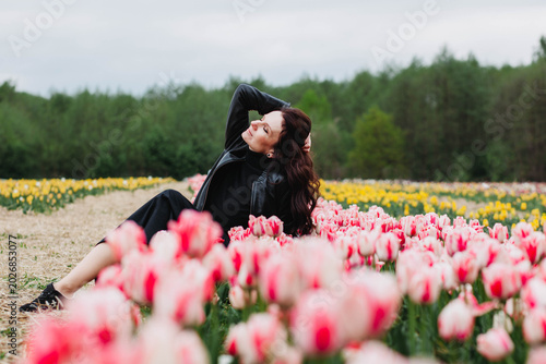 A young woman in a field of tulips. 
