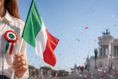 Woman holding Italian flag with tricolor rosette during Republic Day celebration in Rome with confetti.