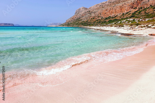 pink sand and crystal turquouise blue waters at Balos Beach at the famous Balos Lagoon in Crete Island, Greece