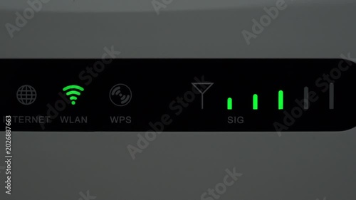 Close up of WiFi router with blinking LED indicators and signal strength bars. Shows wireless connection status and internet activity.