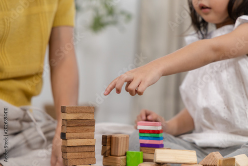 Fotografie Happy children play and learn, education, homeschool little girl create wooden t