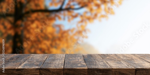 Rustic wooden table in foreground with blurred autumn foliage background (1)