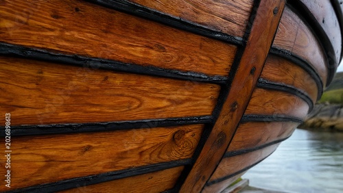 caulk. Black caulk seams on wooden boat hull contrasting with natural wood grain. mobility guides, transit brochures, designed for mobility and urban transit guides, supports logistics messaging.