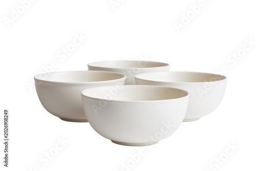 Four empty textured matte ceramic bowls arranged in a cluster on an isolated background featuring macro view of crackle glaze for artisanal kitchen decor product marketing and interior