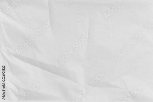 Textured white crumpled paper background with subtle wrinkles and creases.