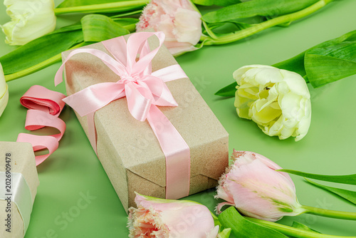 Happy Mothers Day concept. Gift boxes wrapped in craft paper and ribbons, handmade crocheted hearts