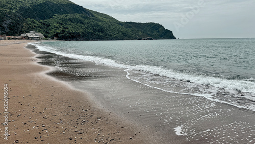 Photos Pearl Coast beach near Čanj Montenegro with gentle waves and green headland
