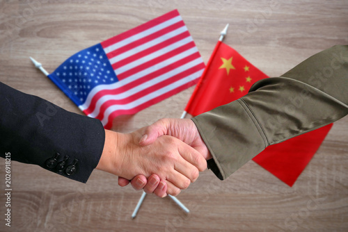 Handshake Between China and USA Flags. American and Chinese Partnership