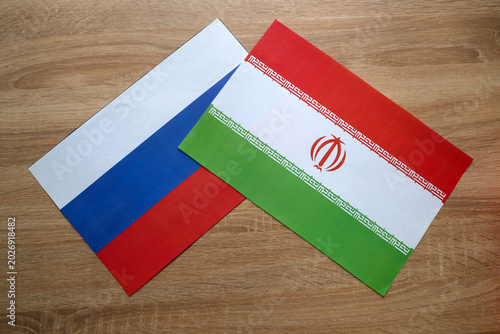 Russian and Iranian Flags on Table. Russia Iran Diplomatic Relations Concept.