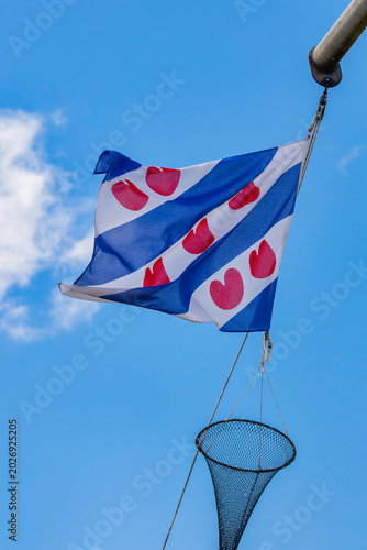 Schilderij op canvas Dutch flag of the province Friesland hanging on a rope of a fishing ship