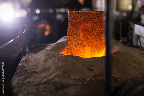 Foto Ferrous metal billet is melted in an induction furnace closeup
