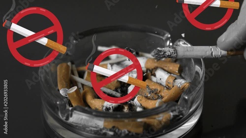 Gloved hand entering and tapping ash in ashtray while no-smoking icons appearing, signaling ban
