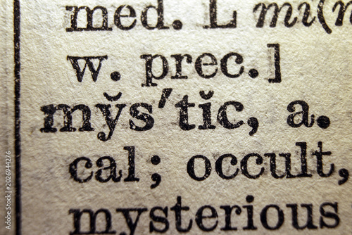 Word mystic on dictionary page, macro close up
