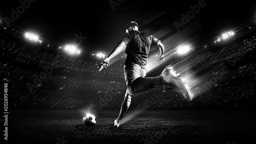 Soccer player running to ball under bright stadium lights in black and white. Concept of fast counterattack, match pressure, sports branding and cinematic football promotion.