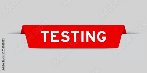 Photos Red color inserted label with word testing on gray background