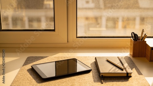 Cozy Workspace with Warm Desk Lamp and Tablet