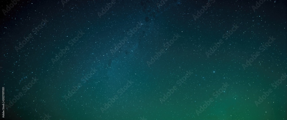 Fototapeta premium bright green and blue celestial sky filled with sparkling stars