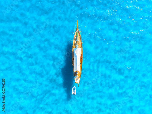 Aerial view of a yacht floating on azure sea water. Mediterranean Sea. Serene...