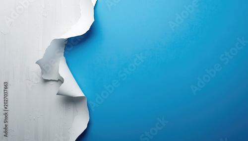 Aged white paint peeling away from blue background with copy space