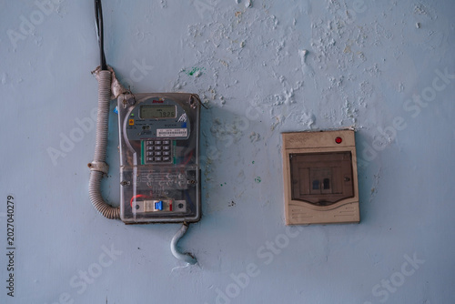 Fotografie Vintage payphone and electrical outlet on a blue wall