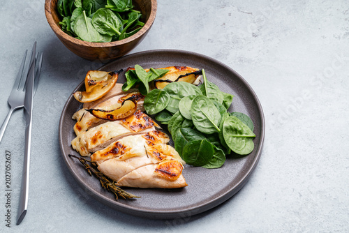 Roasted chicken breast with lemon and halloumi  served with fresh baby spinach leaves
