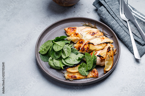 Roasted chicken breast with lemon and halloumi  served with fresh baby spinach leaves