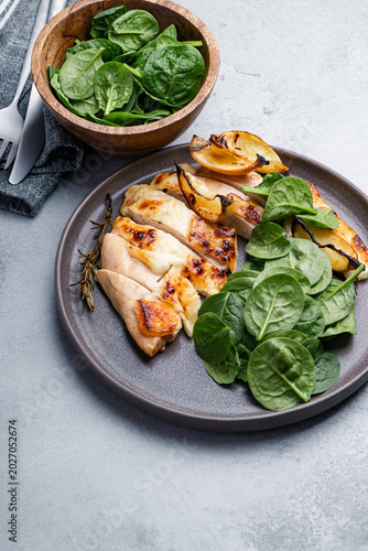Roasted chicken breast with lemon and halloumi  served with fresh baby spinach leaves