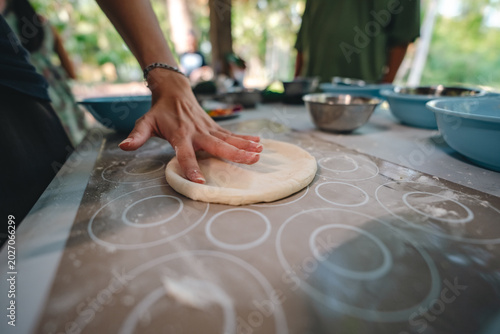 Fotografie Italian pizza cooking process, hand dough flat bread knead table outdoor fresh c
