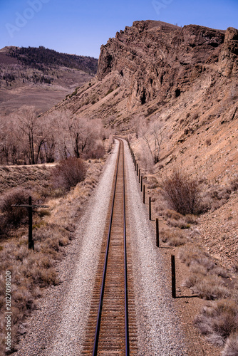 Long narrow view of railroad tracks in the desert