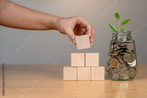 Cuadro en lienzo Close-up of a hand stacking empty wooden blocks, ideal for business planning and financial metaphors