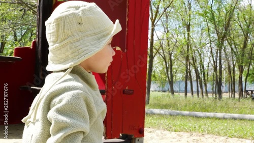 Child enjoys time outdoors on the playground on sunny day