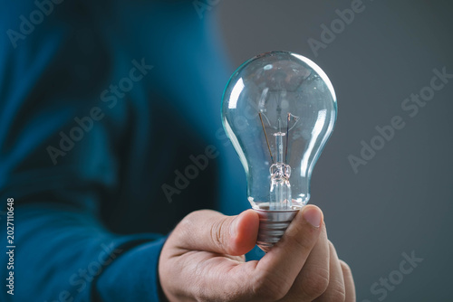 Obraz na płótnie Creative idea concept with light bulb in hand, symbol of innovation inspiration