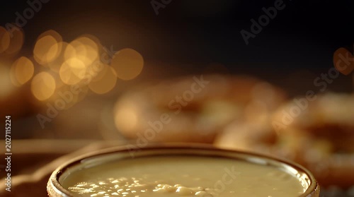 Soft Salted Pretzel Dipping into Creamy Melted Cheese Sauce