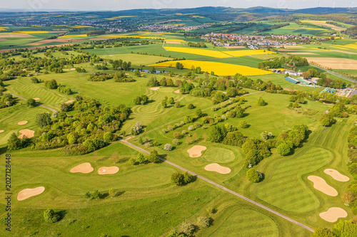 A bird's-eye view of an idyllic golf course nestled amidst the Taunus forests.
