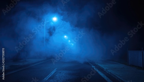 Blue smoke filled empty street under low illumination with copy space background