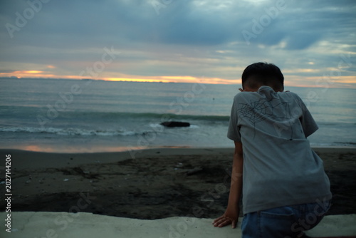 Boy Watching the Ocean Sunset